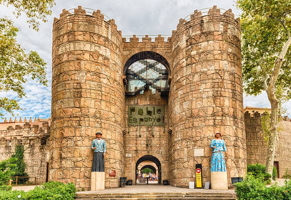 Entrance towers of Poble Espanyol in Barcelona, corporate events venue, with two gegants flanking the gate