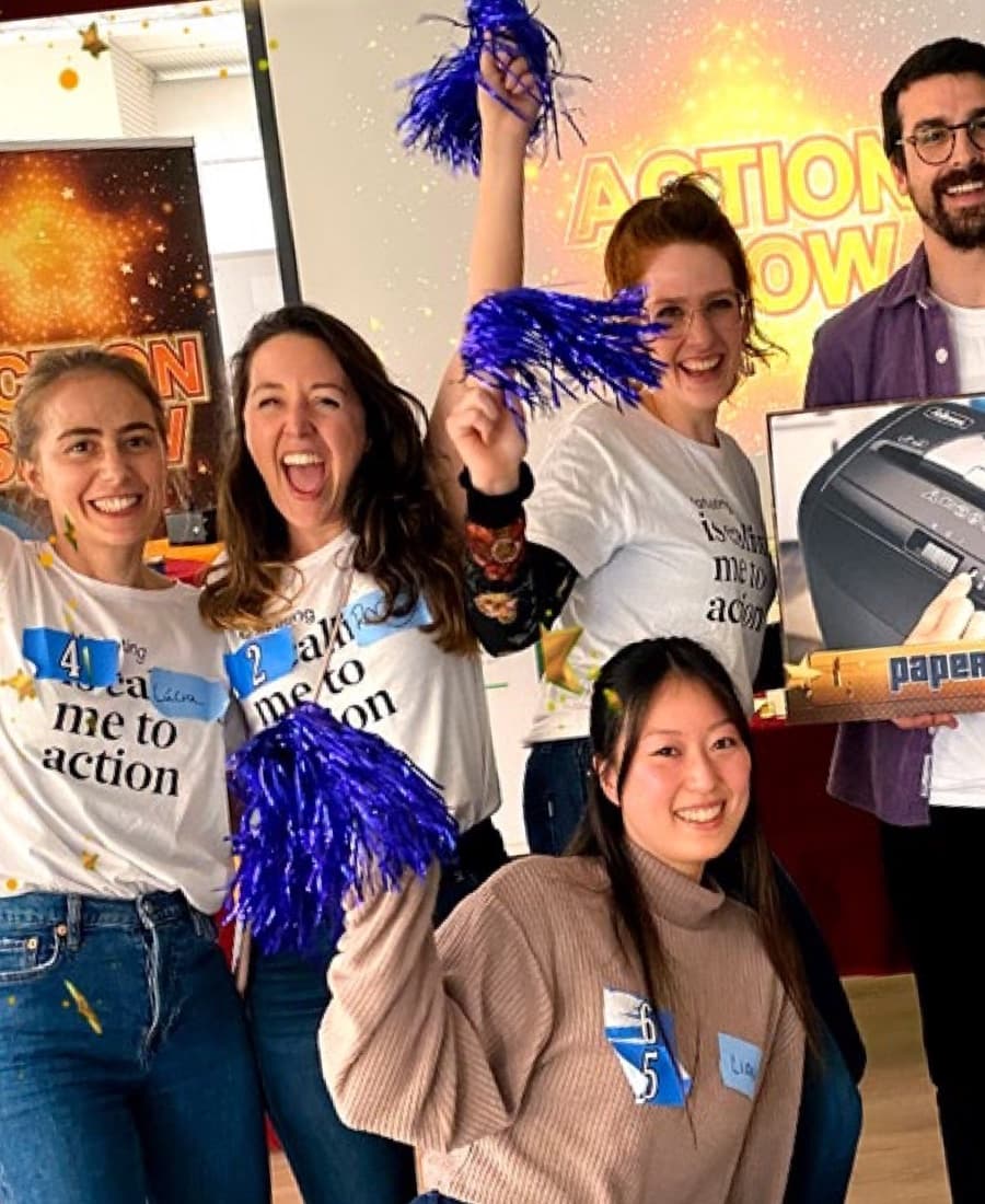 Corporate team with pom-poms celebrating a round of the Action Show game show in Barcelona